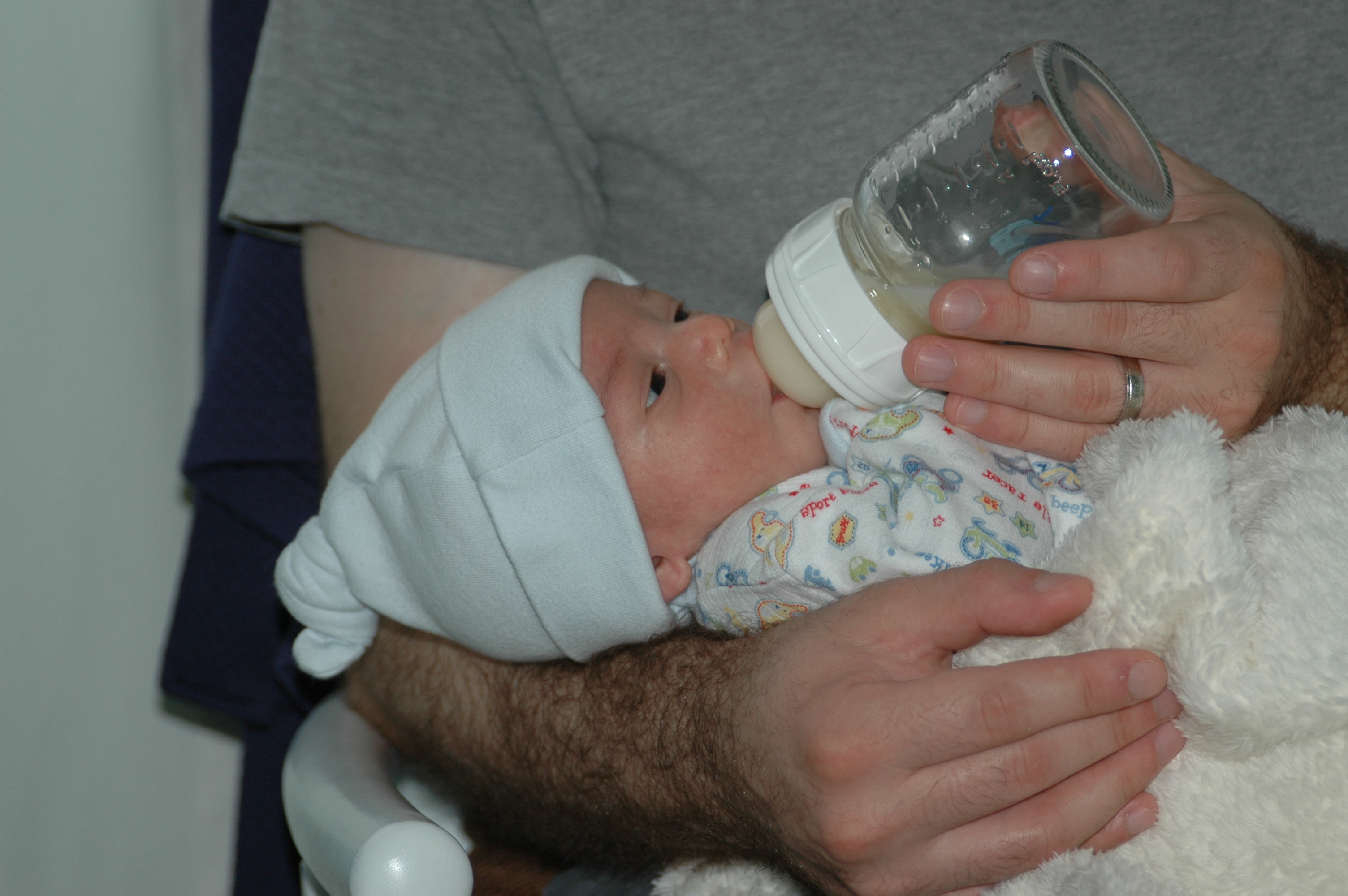 A father bottle-feeding his infant.^[[Image](https://www.flickr.com/photos/ilya/3143204816) by [Ilya Haykinson](https://www.flickr.com/photos/ilya/) is licensed under [CC BY-SA 2.0](https://creativecommons.org/licenses/by-sa/2.0/)]